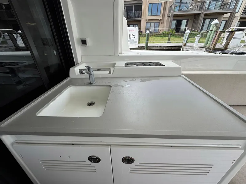 Slide: The Image of Outdoor kitchen area on 2022 Lagoon 46 catamaran with sink and stove. - 41