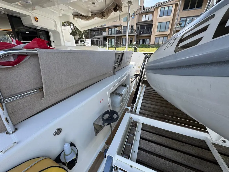 Slide: The Image of 2022 Lagoon 46 yacht deck with seating and docked inflatable boat. - 44