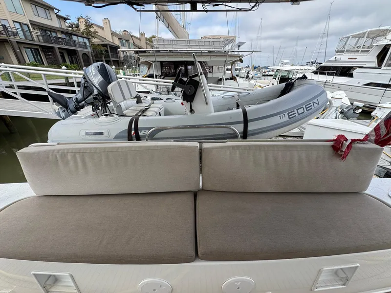 Slide: The Image of Lagoon 46 yacht with inflatable dinghy on deck, docked at marina, 2022 model. - 45