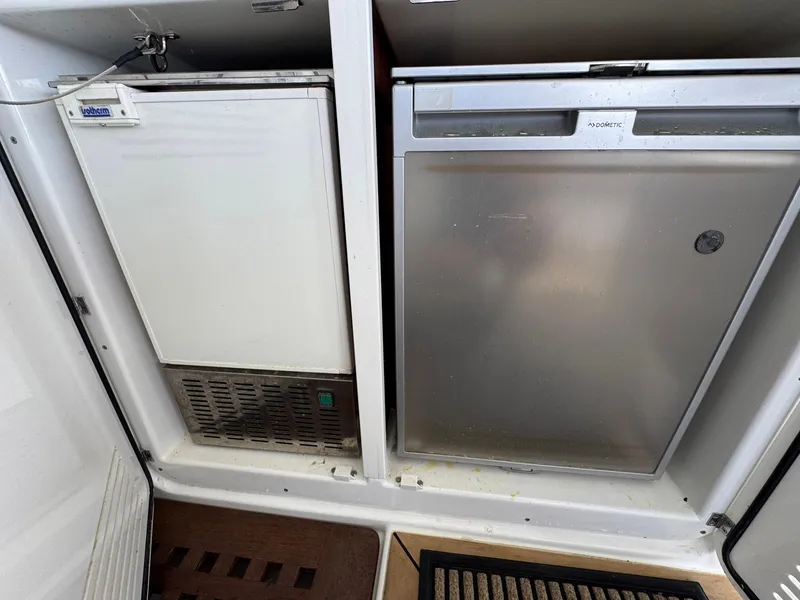 Slide: The Image of Two compact refrigerators in a 2022 Lagoon 46 yacht kitchen. - 47