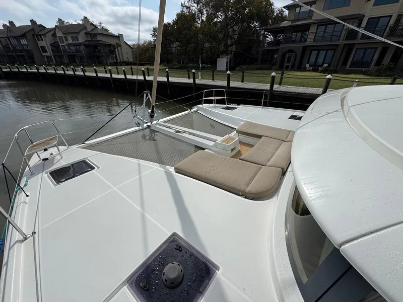 Slide: The Image of 2022 Lagoon 46 catamaran docked, featuring spacious deck and comfortable seating. - 8