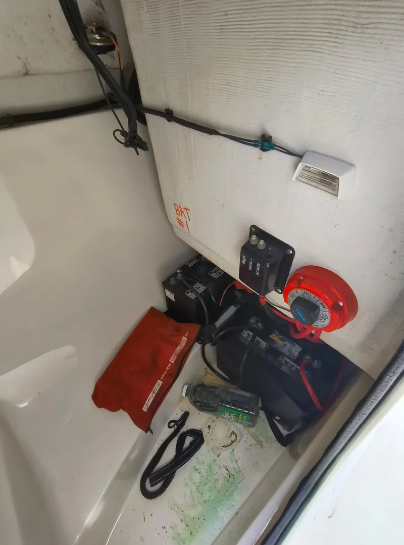 Slide: The Image of Battery compartment of 2001 Boston Whaler 210 Ventura with wiring and safety equipment. - 13