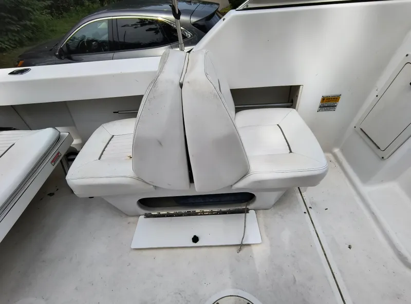 Slide: The Image of 2001 Boston Whaler 210 Ventura boat interior with white seating and storage compartments. - 14