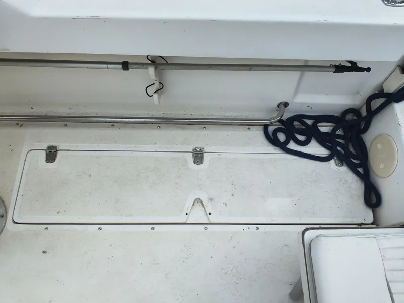 Slide: The Image of 2001 Boston Whaler 210 Ventura deck with storage compartment and coiled rope. - 15