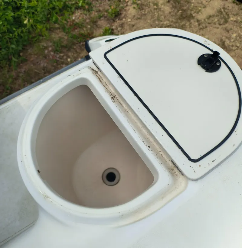 Slide: The Image of Open storage compartment on a 2001 Boston Whaler 210 Ventura boat. - 16