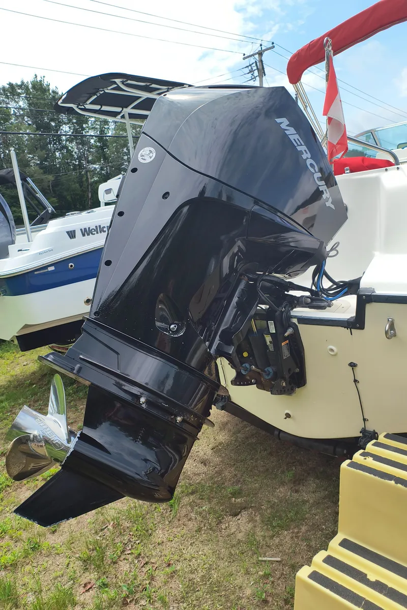 Slide: The Image of 2001 Boston Whaler 210 Ventura with Mercury outboard motor, displayed outdoors. - 19