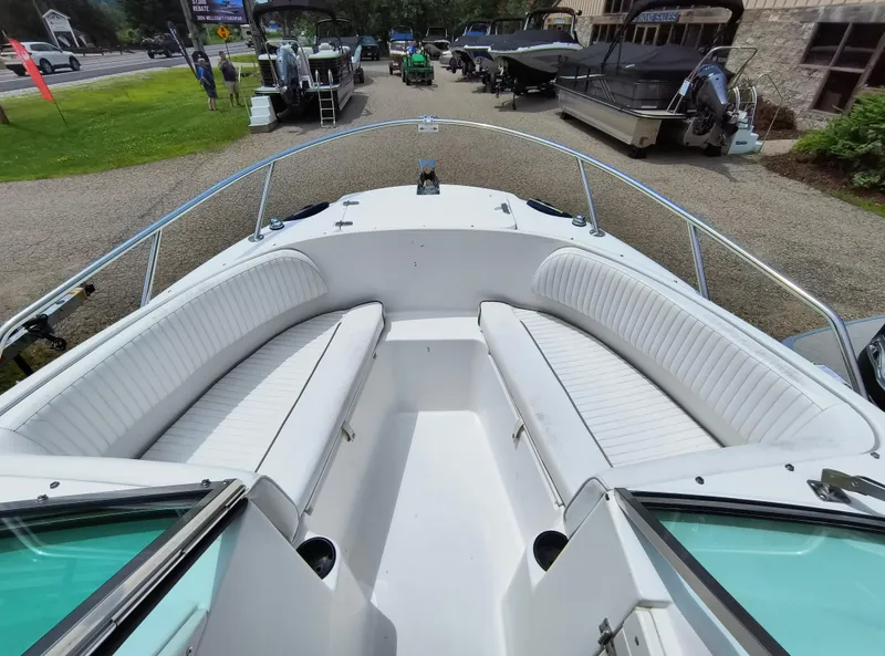 Slide: The Image of 2001 Boston Whaler 210 Ventura boat interior with white seating, displayed outdoors. - 4