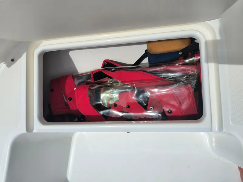 Slide: The Image of Storage compartment on a 2001 Boston Whaler 210 Ventura boat with red life jackets. - 7