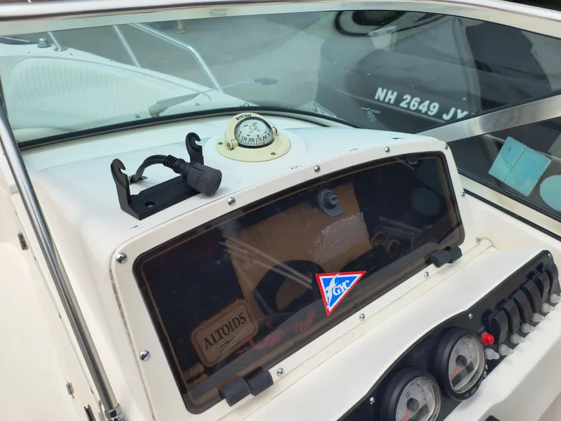 Slide: The Image of Dashboard of a 2001 Boston Whaler 210 Ventura boat with compass and gauges. - 8