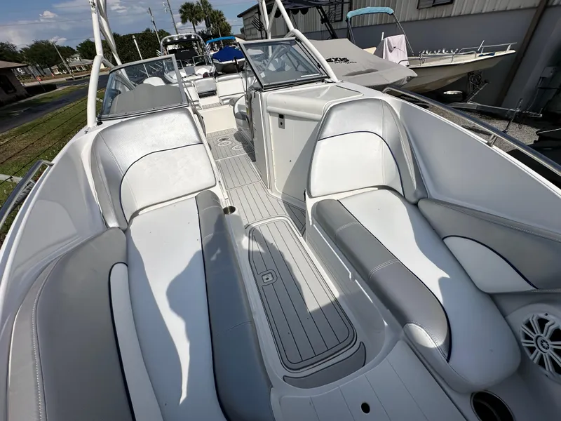 Slide: The Image of 2007 Ebbtide 2460 SS Fun Cruiser DC interior with white seating and sleek design. - 10