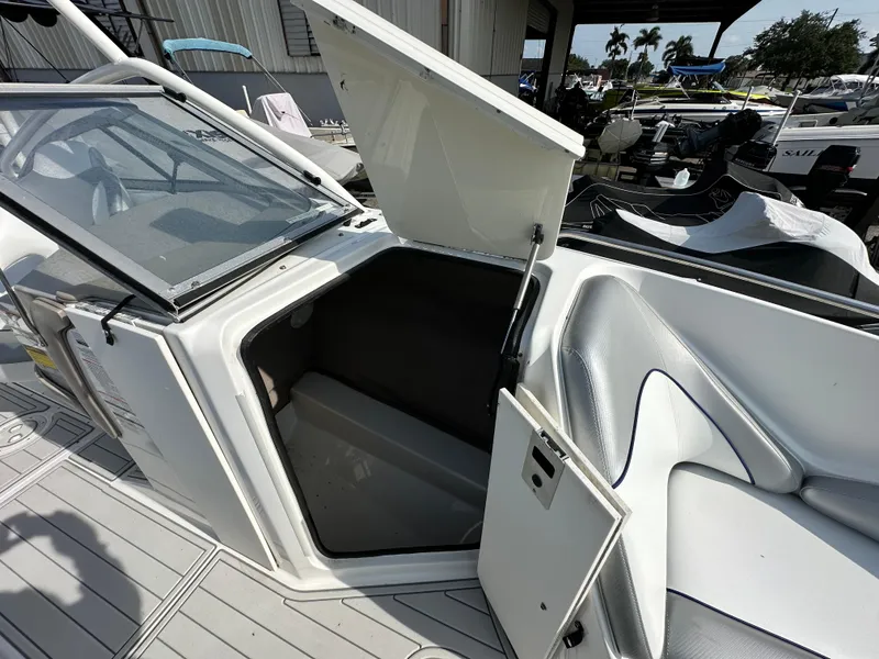 Slide: The Image of 2007 Ebbtide 2460 SS Fun Cruiser DC boat interior with open storage compartment. - 12