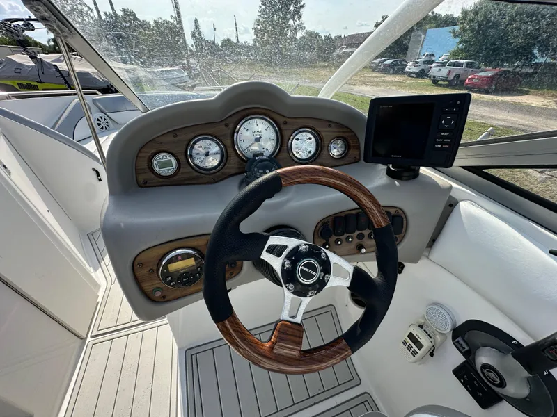 Slide: The Image of 2007 Ebbtide 2460 SS Fun Cruiser DC dashboard with steering wheel and gauges. - 13