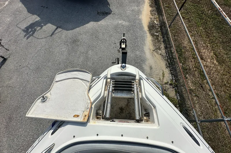 Slide: The Image of 2007 Ebbtide 2460 SS Fun Cruiser DC boat bow with open hatch and ladder. - 19