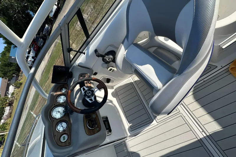 Slide: The Image of 2007 Ebbtide 2460 SS Fun Cruiser DC cockpit with steering wheel and gauges. - 20