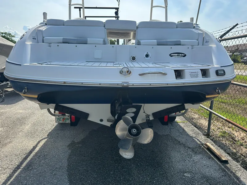 Slide: The Image of 2007 Ebbtide 2460 SS Fun Cruiser DC boat, rear view, docked outdoors. - 4