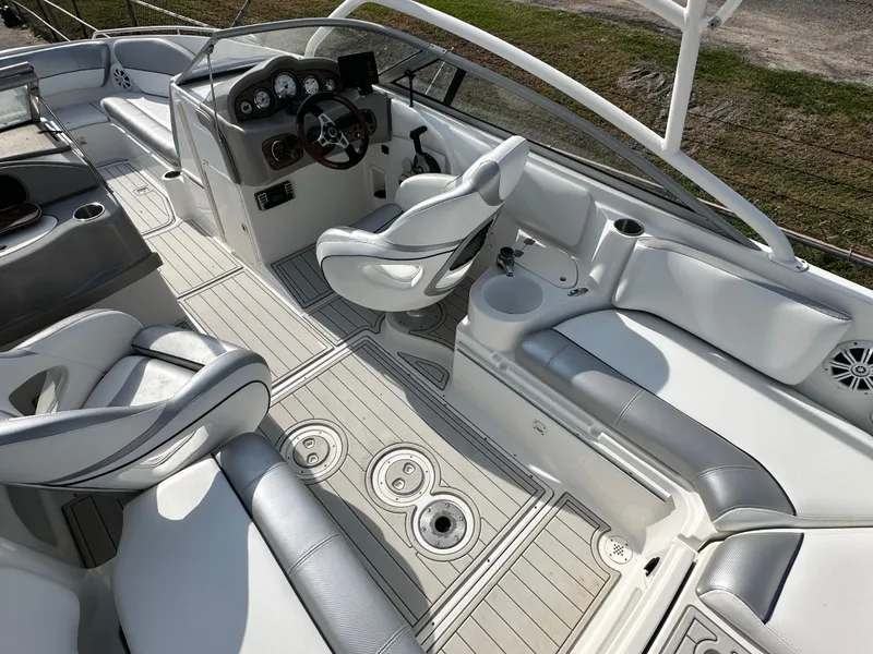 Slide: The Image of 2007 Ebbtide 2460 SS Fun Cruiser DC interior with white seating and modern dashboard. - 7