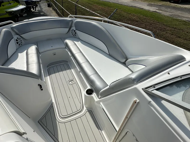 Slide: The Image of 2007 Ebbtide 2460 SS Fun Cruiser DC boat interior with gray seating and deck. - 8