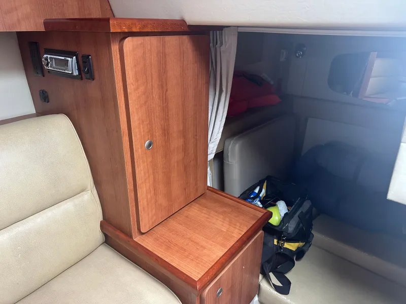 Slide: The Image of Interior of 2009 Cruisers 300 CXi Express with wood cabinetry and beige seating. - 14