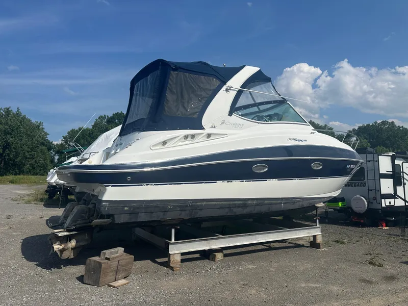 Slide: The Image of 2009 Cruisers 300 CXi Express boat on dry dock under clear sky. - 2