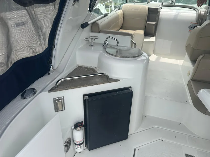 Slide: The Image of 2009 Cruisers 300 CXi Express boat interior with seating, sink, and mini fridge. - 4