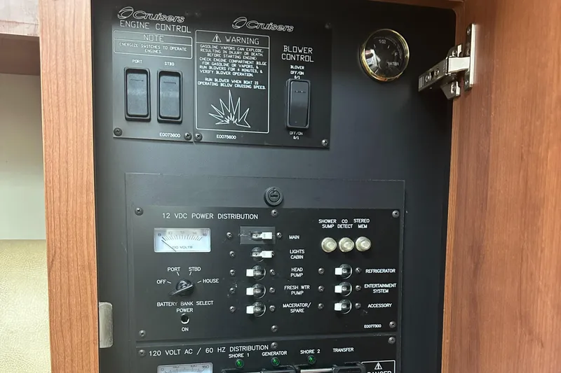 Slide: The Image of Control panel of 2009 Cruisers 300 CXi Express boat, featuring engine and power distribution switches. - 15