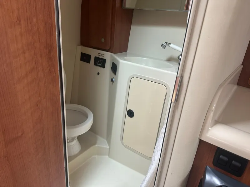 Slide: The Image of 2009 Cruisers 300 CXi Express boat bathroom with toilet and sink. - 18