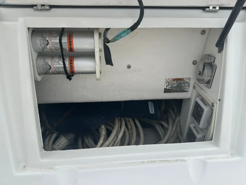 Slide: The Image of 2009 Cruisers 300 CXi Express electrical compartment with cables and warning labels. - 29