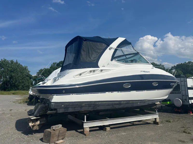 Slide: The Image of 2009 Cruisers 300 CXi Express boat on dry dock under blue sky. - 31