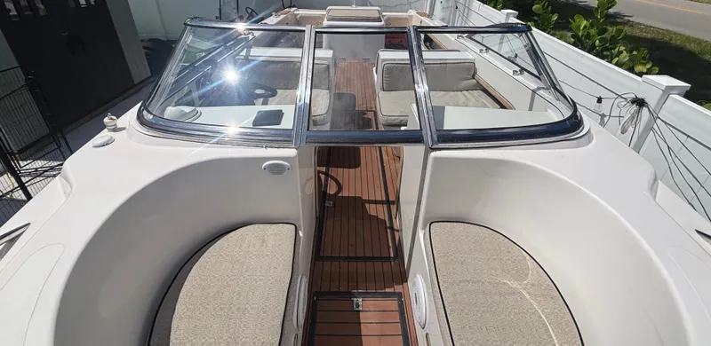 Slide: The Image of 2010 Westport 23 Custom Tender with spacious seating and sleek design, docked outdoors. - 13