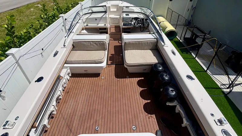 Slide: The Image of 2010 Westport 23 Custom Tender with spacious deck and seating, docked outdoors. - 14