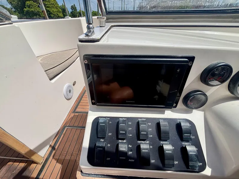 Slide: The Image of Control panel of 2010 Westport 23 Custom Tender with Garmin display and switches. - 18