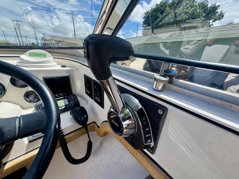 Slide: The Image of Control panel of 2010 Westport 23 Custom Tender with steering wheel and throttle lever. - 22