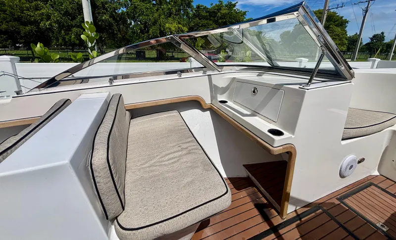 Slide: The Image of Westport 23 Custom Tender 2010 interior with cushioned seating and wooden flooring. - 23