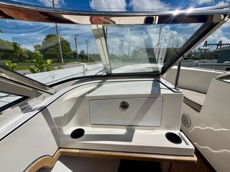 Slide: The Image of Westport 23 Custom Tender 2010 boat interior with windshield and storage compartment. - 24