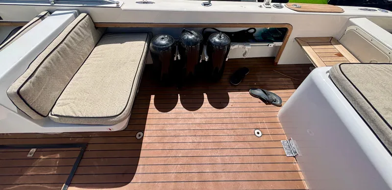 Slide: The Image of 2010 Westport 23 Custom Tender interior with cushioned seating and teak flooring. - 26