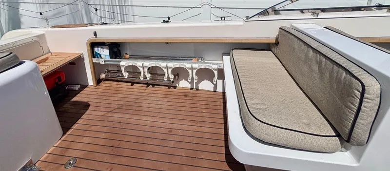 Slide: The Image of 2010 Westport 23 Custom Tender with wooden deck and cushioned seating. - 28