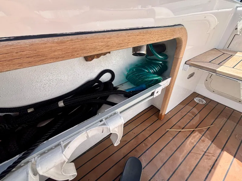 Slide: The Image of Storage compartment on 2010 Westport 23 Custom Tender with coiled hose and ropes. - 29