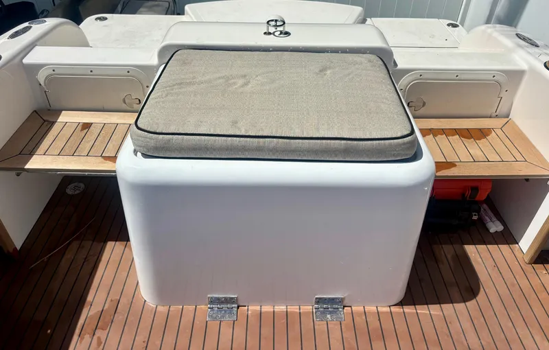 Slide: The Image of Westport 23 Custom Tender 2010 boat interior with cushioned seating and wooden flooring. - 30