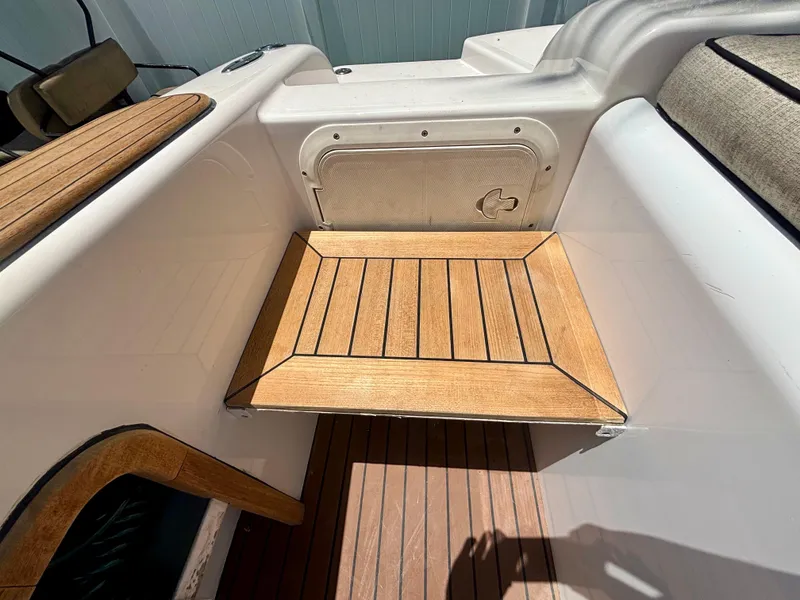 Slide: The Image of Teak deck detail on 2010 Westport 23 Custom Tender boat, showcasing elegant wood finish. - 32