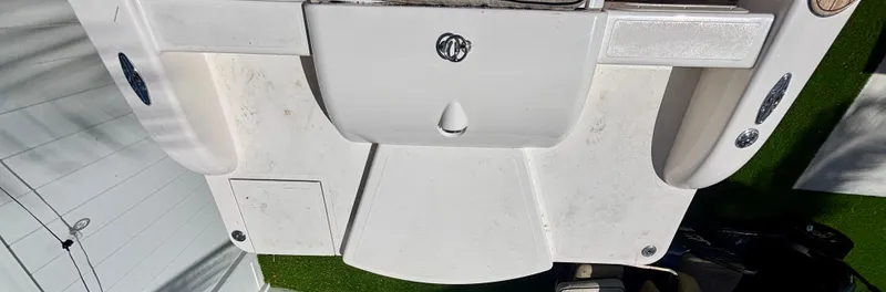 Slide: The Image of 2010 Westport 23 Custom Tender boat deck, featuring a clean, white surface with storage compartments. - 33