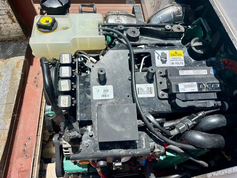Slide: The Image of Engine compartment of a 2010 Westport 23 Custom Tender, showcasing various components and wiring. - 36