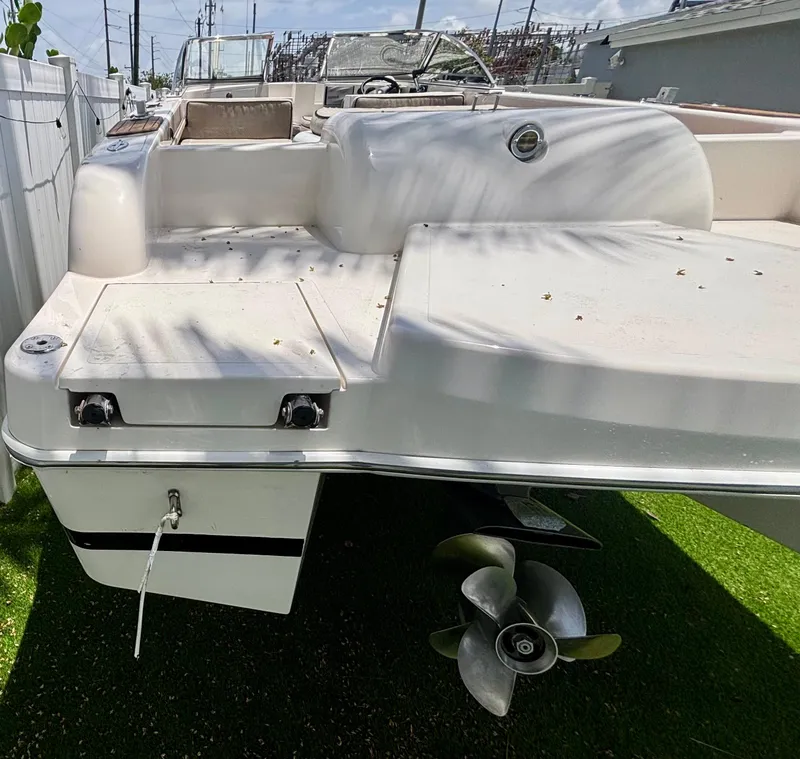 Slide: The Image of 2010 Westport 23 Custom Tender boat, rear view with propeller, parked on grass. - 6