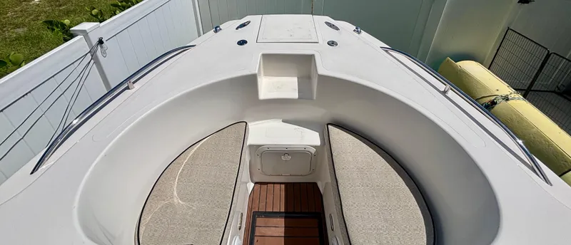 Slide: The Image of Westport 23 Custom Tender 2010 boat interior with cushioned seating and wooden flooring. - 8