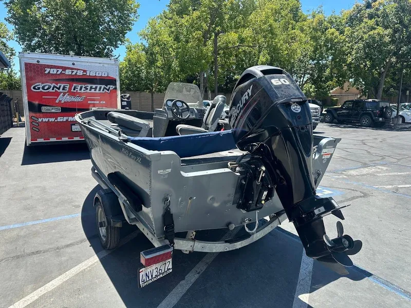 Slide: The Image of 2015 Lund 1625 Fury XL SS boat with Mercury 60 outboard motor in parking lot. - 10