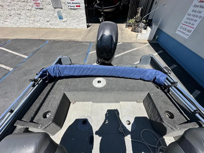 Slide: The Image of 2015 Lund 1625 Fury XL SS boat interior with motor, parked in a lot. - 11