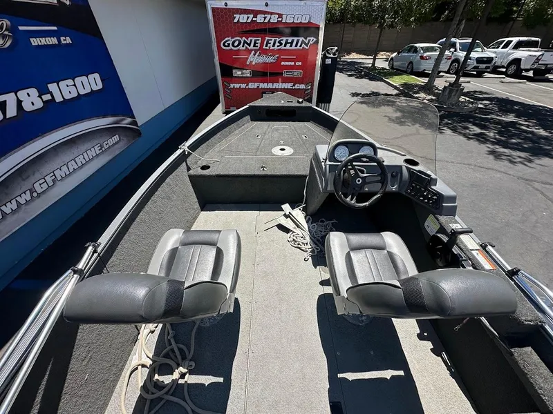 Slide: The Image of 2015 Lund 1625 Fury XL SS fishing boat interior with two seats and steering console. - 12