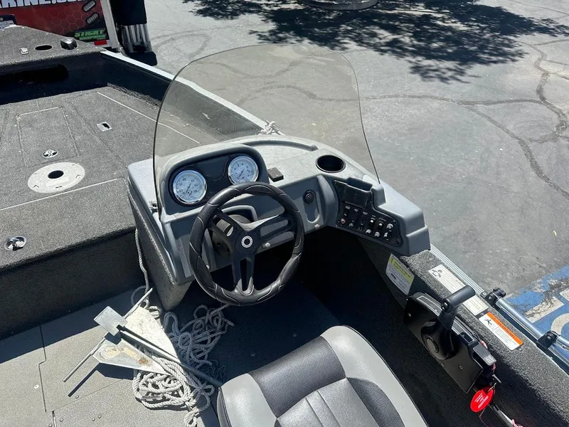 Slide: The Image of 2015 Lund 1625 Fury XL SS boat interior with steering wheel and dashboard controls. - 14