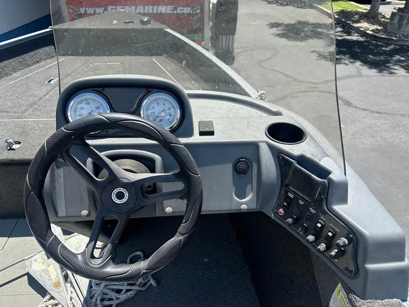 Slide: The Image of 2015 Lund 1625 Fury XL SS boat dashboard with steering wheel and gauges. - 15