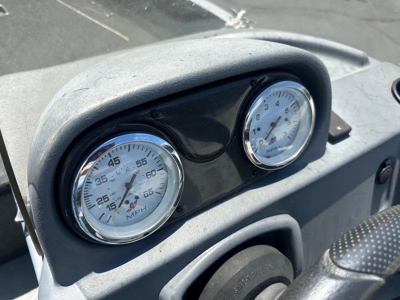 Slide: The Image of Dashboard of a 2015 Lund 1625 Fury XL SS boat with speedometer and tachometer. - 16