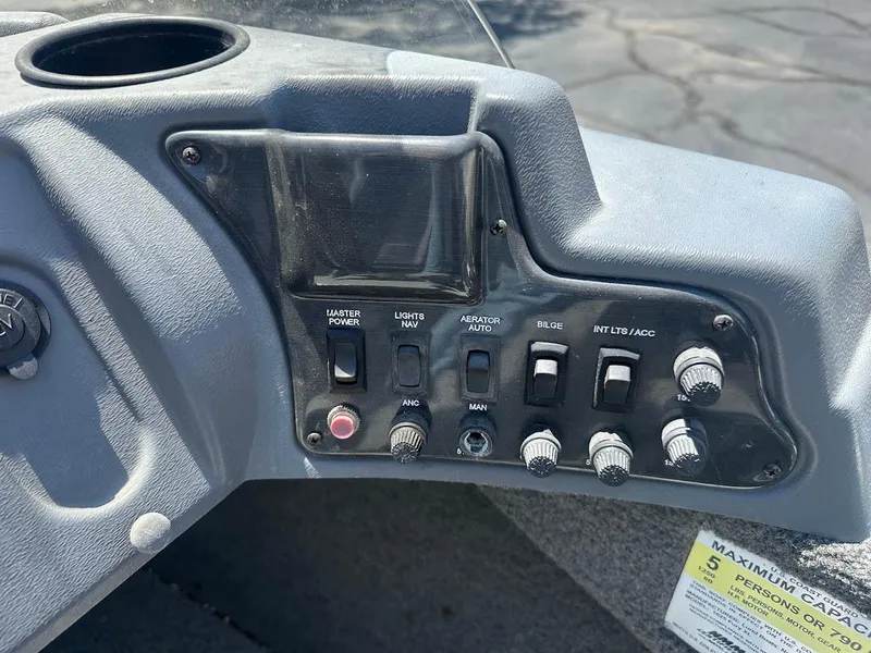 Slide: The Image of Control panel of a 2015 Lund 1625 Fury XL SS boat with various switches and knobs. - 17